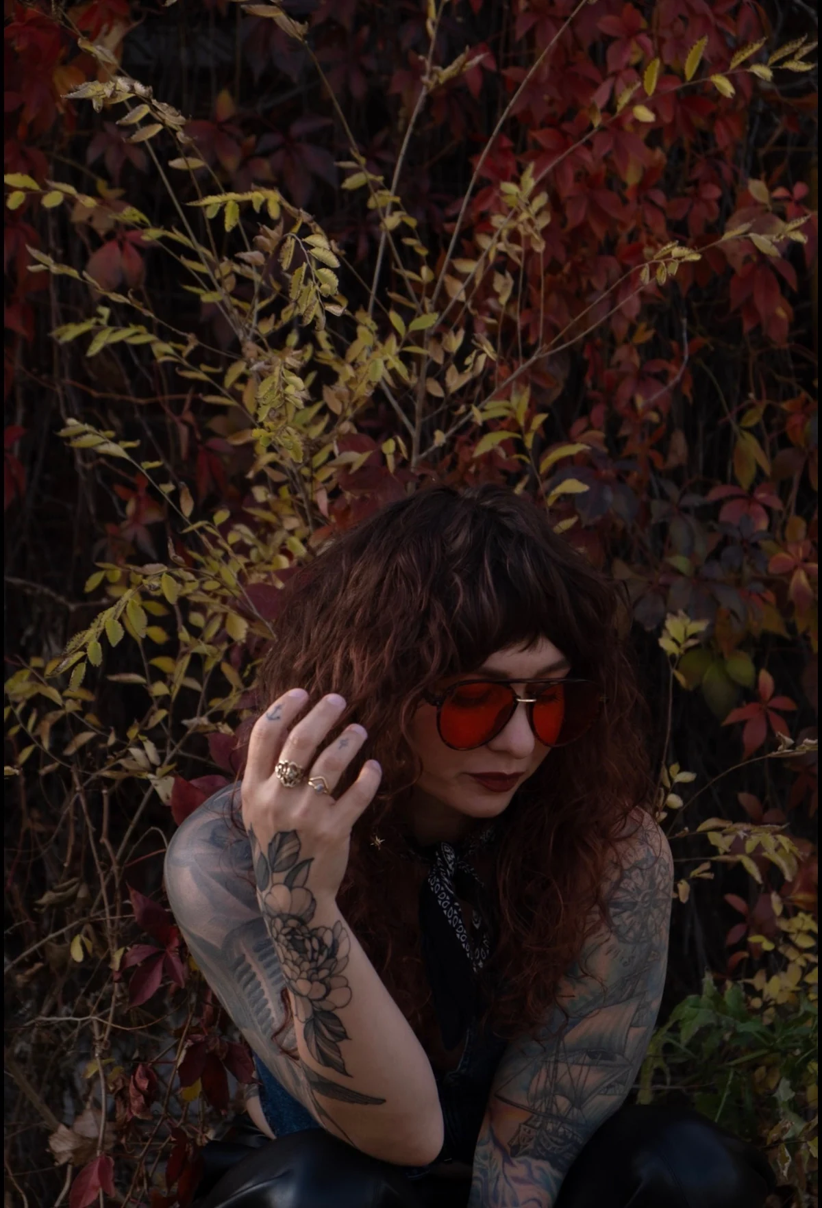 Tyra Whitson looking down among autumn foliage